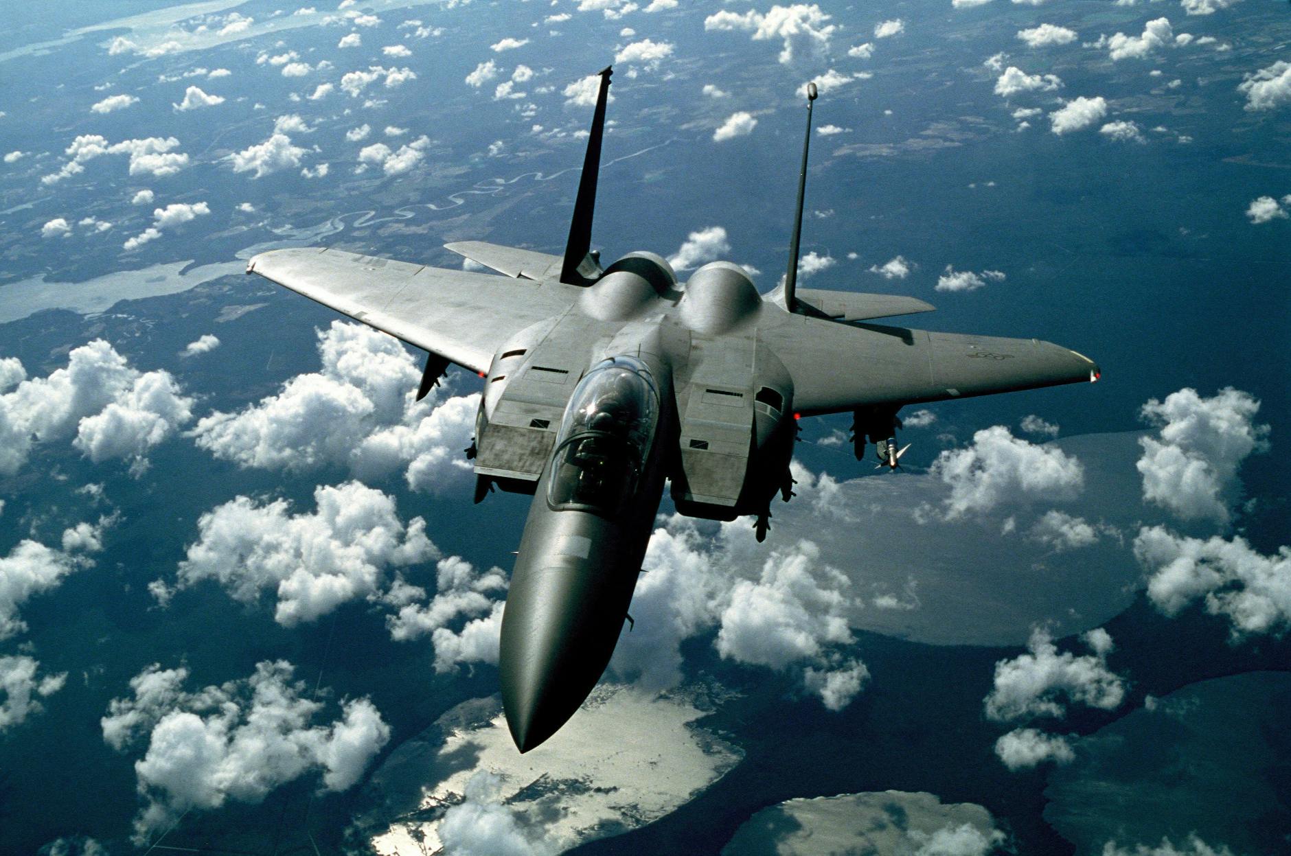 Gray Fighter Jet in White Clouds